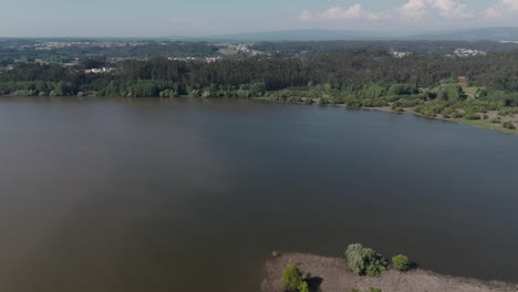 Aerial-view-of-Pateira-de-Fermentelos-with-lush-greenery-and-forest-in-Aveiro,-Portugal