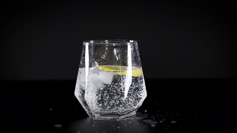 glass of sparkling water with lemon and ice