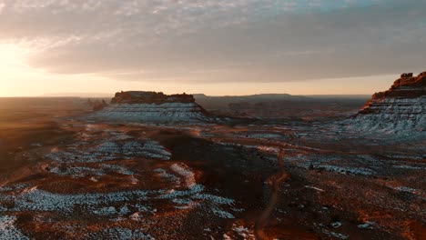 cinematic shot from a snowy sunrise in valley of the gods utah