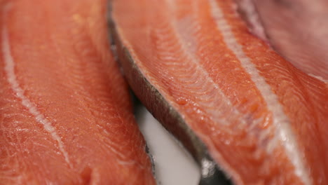 fresh salmon meat prepared for sushi in a japanese restaurant kitchen - macro