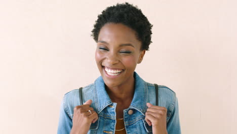 edgy woman laughing and carrying a backpack