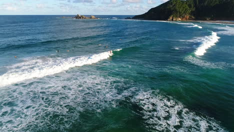 aerial shots of surfers riding waves at the beach