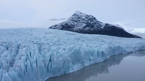 thick frozen ice in the glacial lake of fjallsa rlo n in iceland - aerial shot