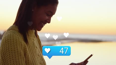 animation of heart icon with increasing numbers over african american woman using smartphone