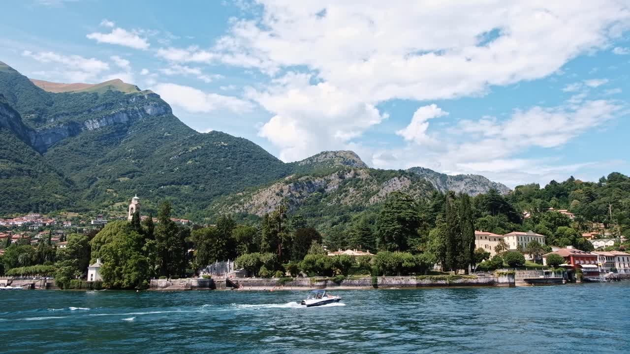 Cinematic shot of Bellagio town, Como lake and mountains from a boat in Lombardy, Italy