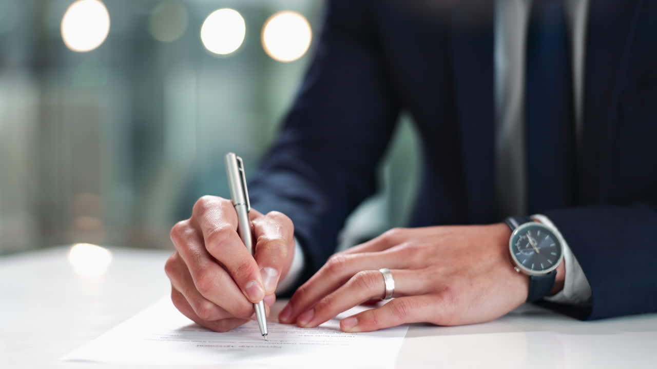 A businessman signing a document