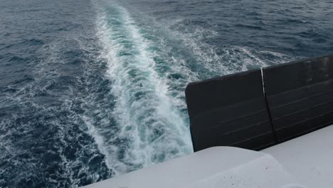 view of the waves from the back of a public ferry boat