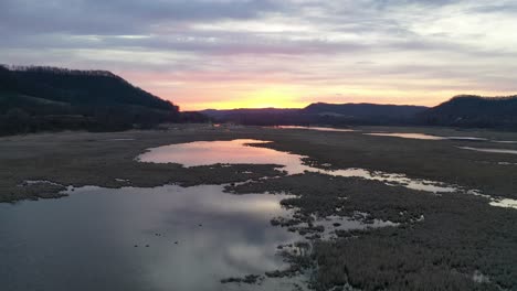 sunrise or sunset over a marsh landscape