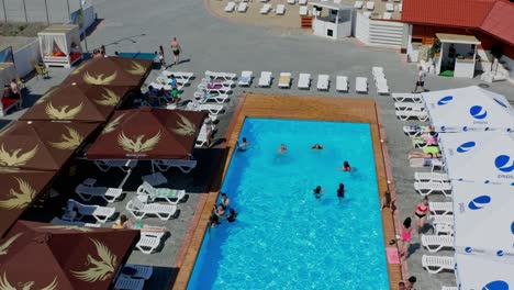 friends having party in pool. aerial view of friends having party in swimming pool