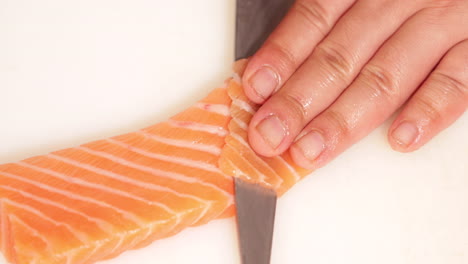 slicing delicious fresh tuna meat for kabuki sushi - close up