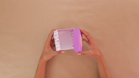 holding and opening handmade cardboard valentines day gift box