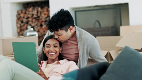 Happy-couple,-kiss-and-relax-with-tablet-in-home