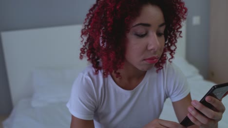 depressed young woman in headphones listening to sad music, watching video