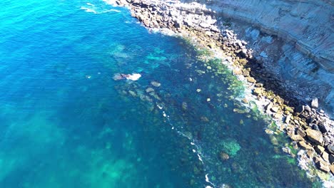 aerial-view-of-rugged-coast-,-blue-waves,-4k