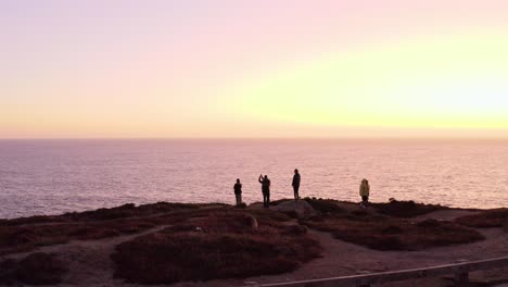 aerial: drone, people watching the sunset, descending view