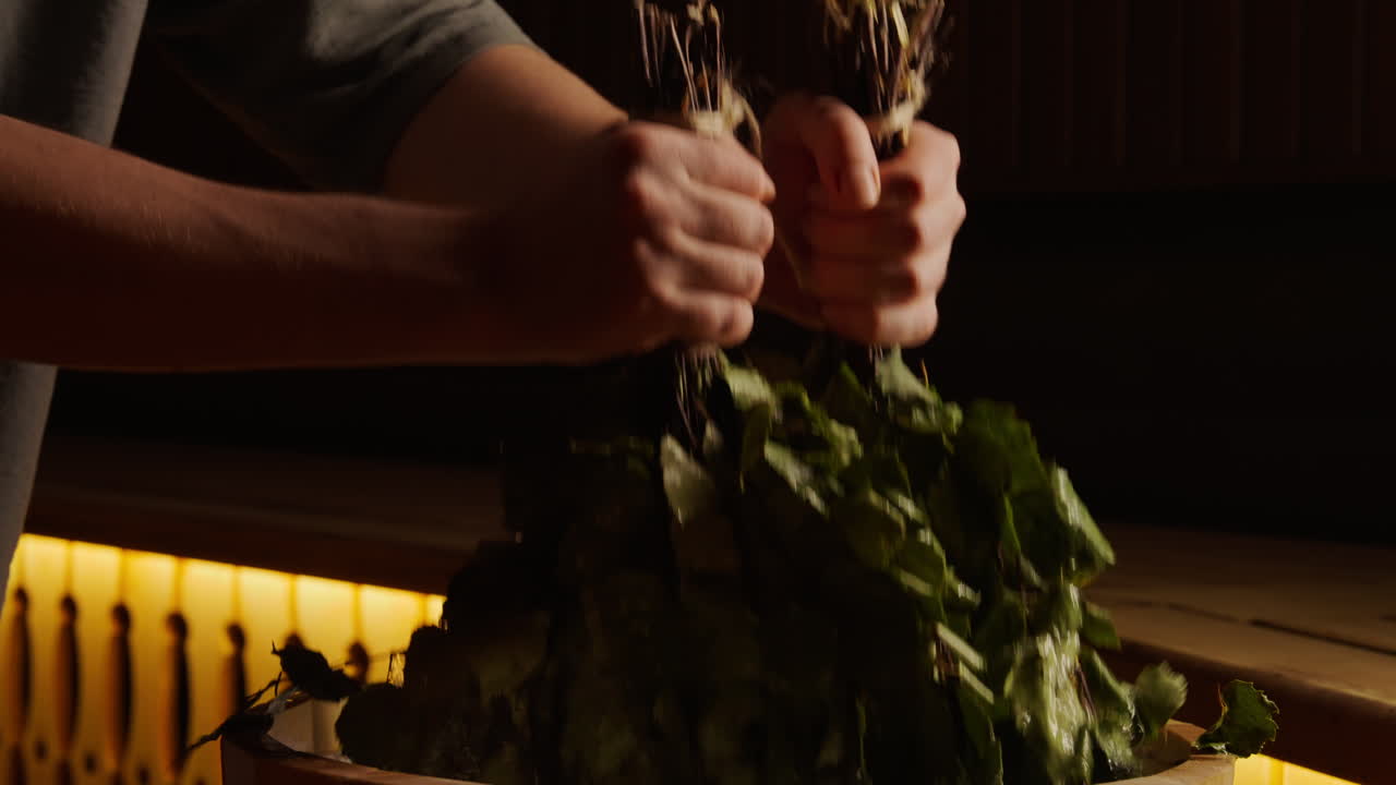 Preparing a traditional Russian bath (Banya) treatment with birch leaves