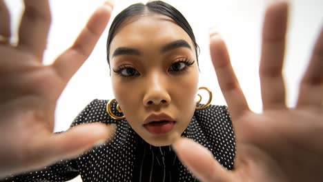young asian model reaching towards camera in slow motion montage