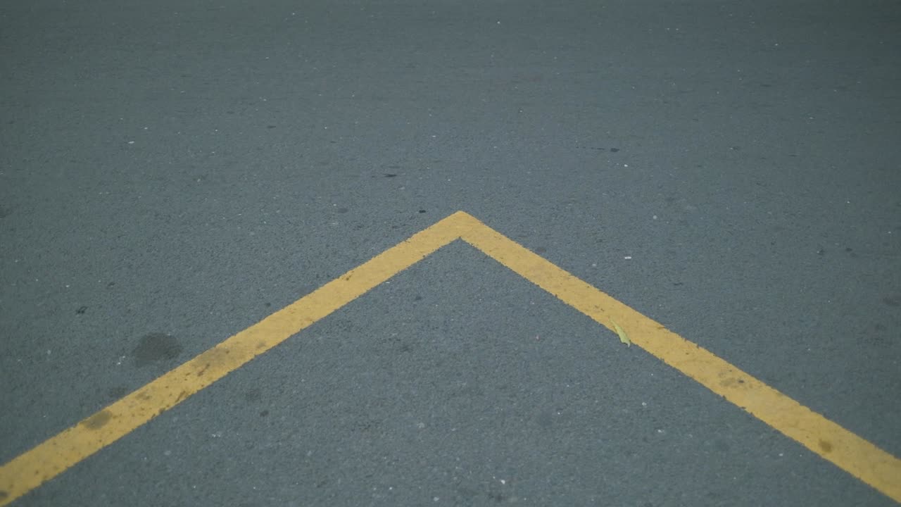 Indonesian yellow road sign on an asphalt road. Motorcycle passing by.