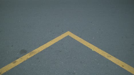 indonesian yellow road sign on an asphalt road. motorcycle passing by.
