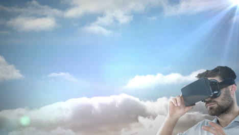 caucasian man wearing vr headset against spot of light and clouds in the sky