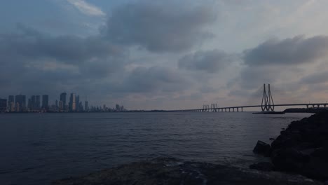 the sun sets over the mumbai sealink and mahim bay