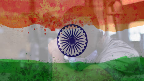 Composition-of-man-wearing-face-mask-over-indian-flag