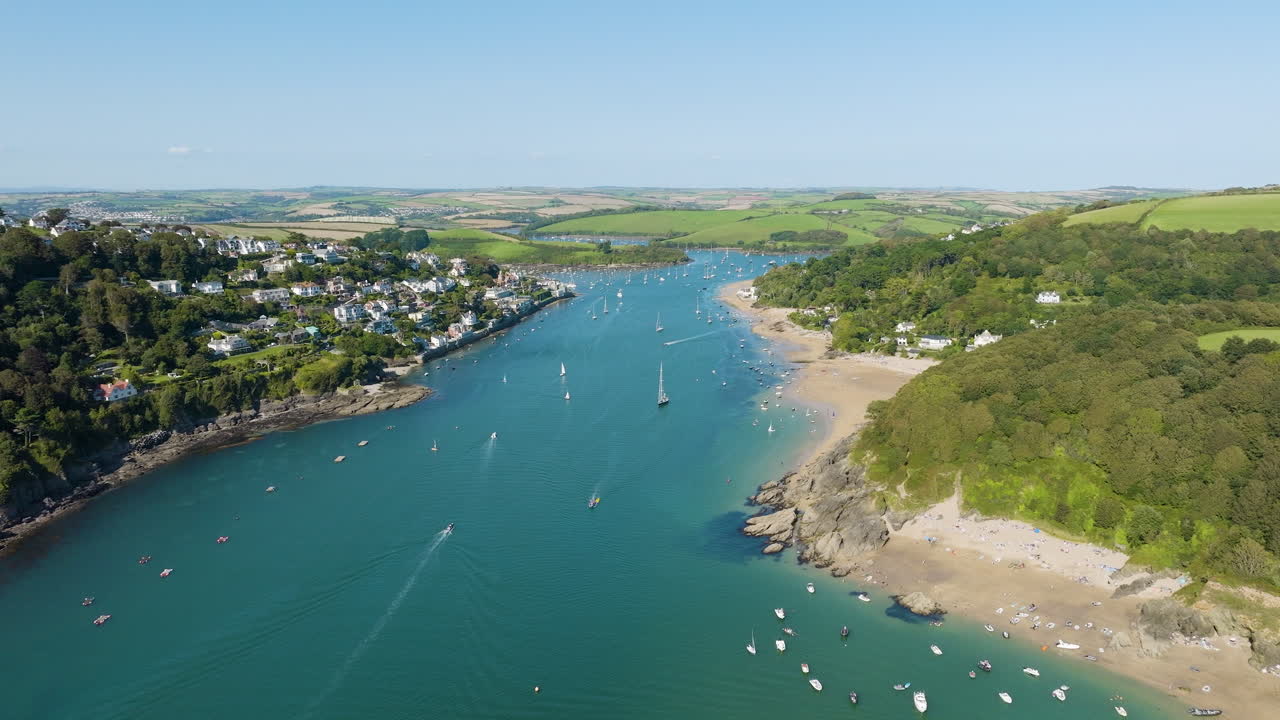 Aerial view of a coastal village and bay in Cornwall, UK