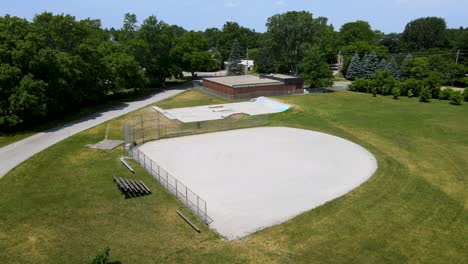 flying around a baseball diamond and skate park on a sunny day in a small town near london, ontario