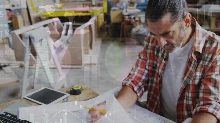 Animation of world map and data processing over caucasian male carpenter working in workshop