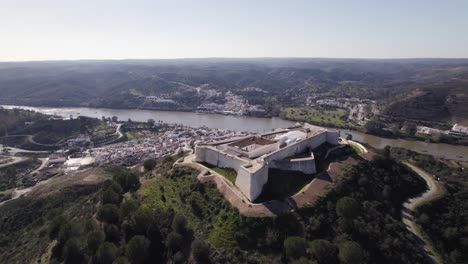 aerial view of impressive san marcos castle overlooking guadiana river, spain