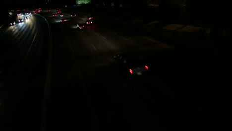 Stationary-tilt-shot-of-cars-on-the-freeway-at-night