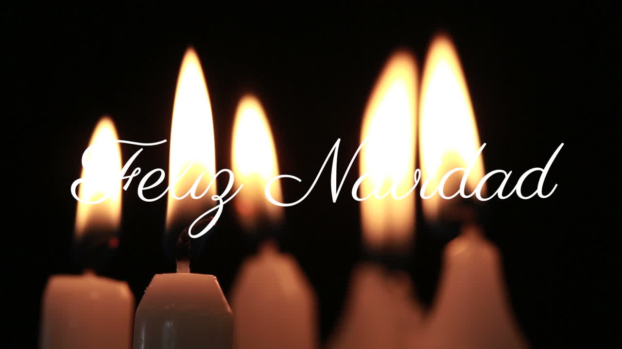 Burning candles with Feliz Navidad text animation over dark background