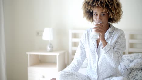 Woman-Drinking-A-Milk-On-Bed