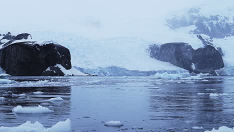 aerial drone shot of antarctica landscape, glacier and mountain scenery on the antarctic peninsula in the southern ocean, in a snow and ice covered landscape in cold weather