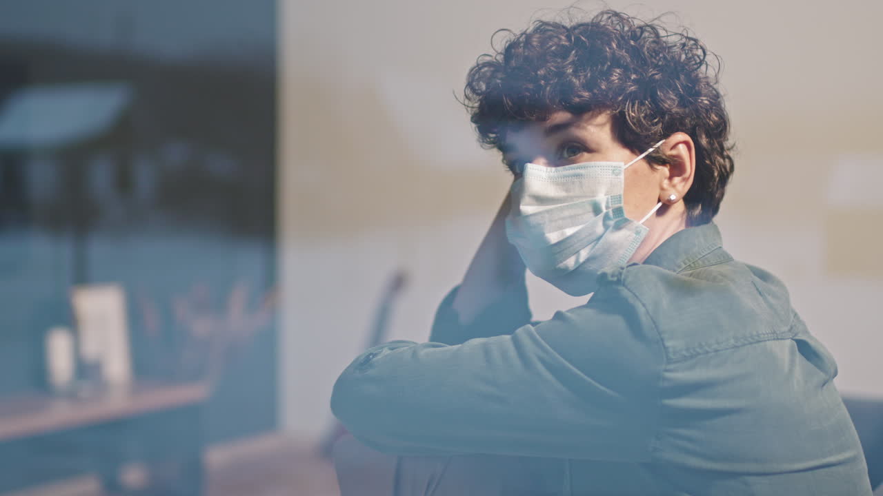 Woman In Protective Mask Looking At Window