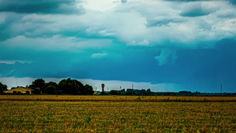 a time lapse shot of a wind shear above a small neighbourhood and a field landscape