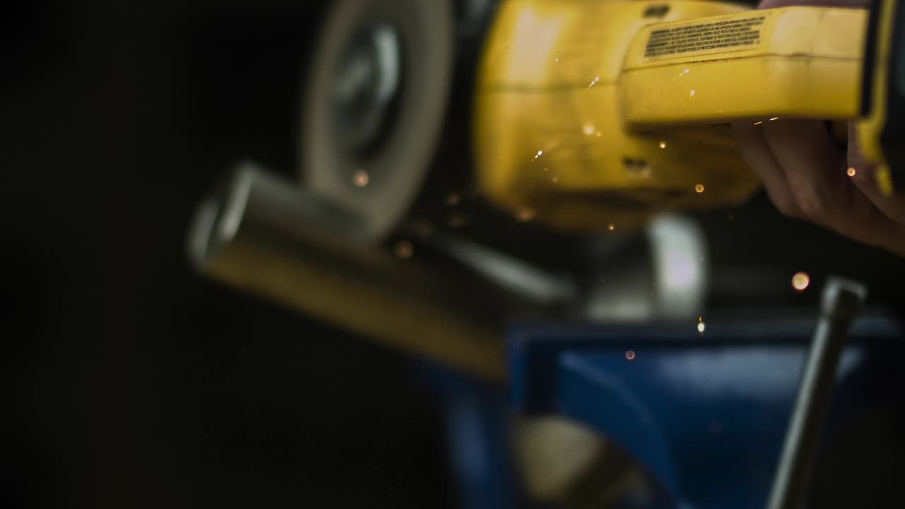Sparks Coming Out From Angle Grinder Cutting Metal In The Workshop. - close up, slow motion