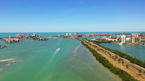 Aerial-view-of-a-small-yacht-sailing-in-Clearwater-Beach-in-Florida-on-a-summer-day