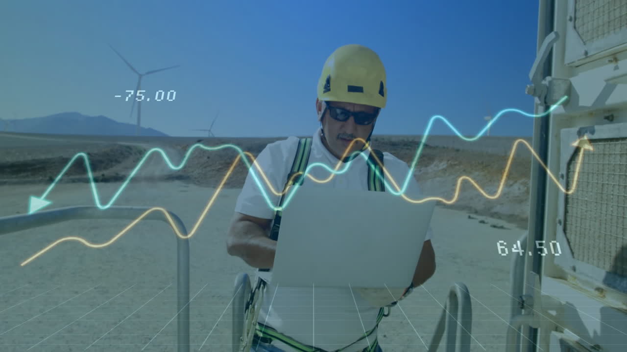 field technician typing on laptop on platform at wind farm, showing holographic data overlays