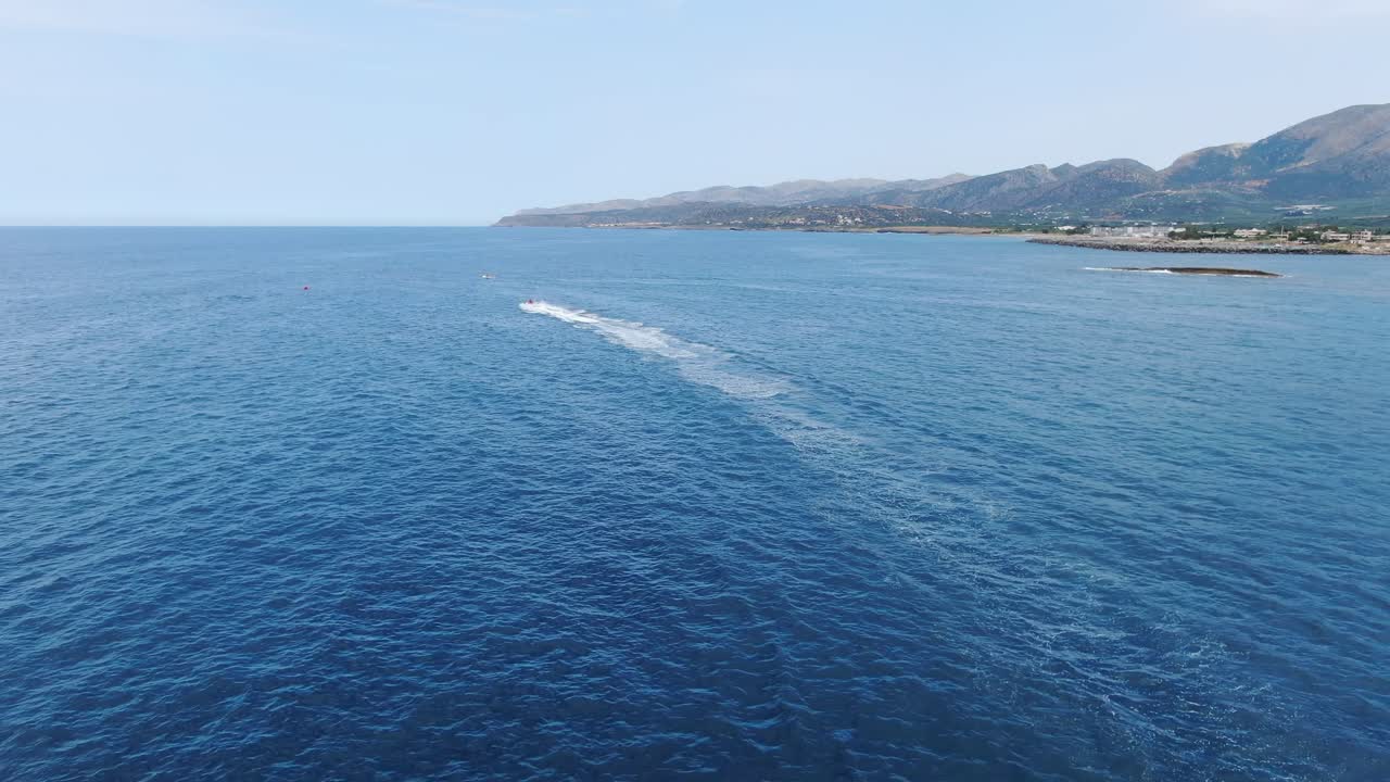 Aerial fly over jet ski racing on the Aegean Sea on a beautiful summer day