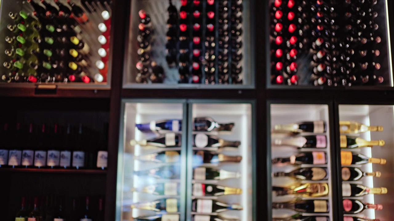 View of a wine storage wall with different sections filled with bottles