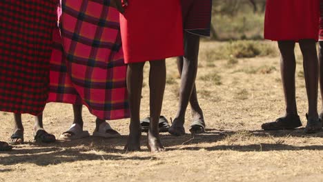 cropped view of masai mara men tribe in their traditional jumping dance ceremony in kenya, africa