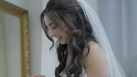 Bride-reacting-to-video-from-Groom.-Blushing