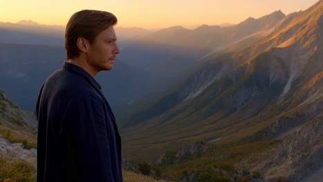 man contemplating mountain sunset
