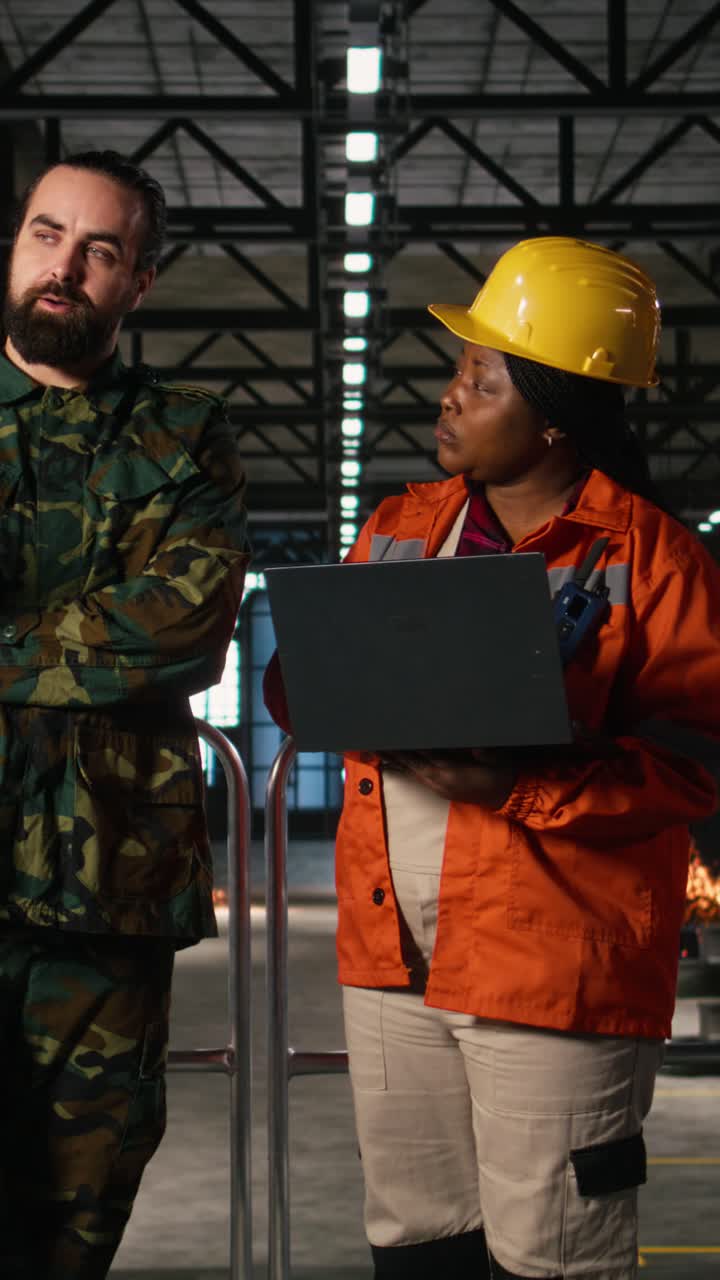 Vertical Video Military officer and engineer discussing armament production