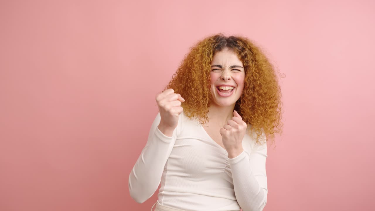 Woman having an idea and getting excited on pink background