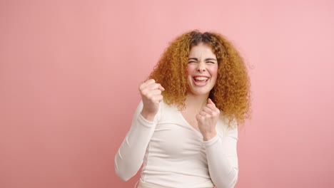 woman having an idea and getting excited on pink background