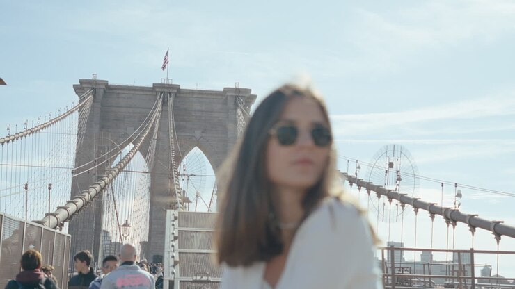 Woman with sunglasses near Brooklyn Bridge