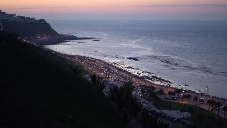 static aerial footage of tanger city, morocco, showing traffic and pedestrians on the road at nighttime