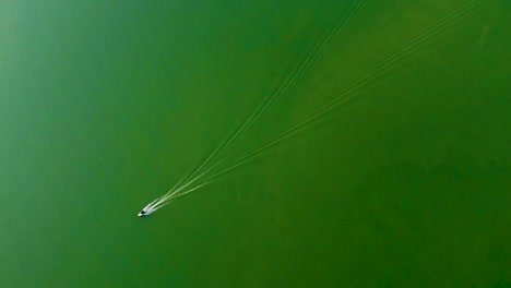 isolated speed boat running on lake water from top angle video is taken at umiyam lake shillong meghalaya india